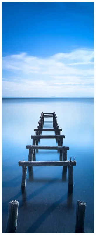 Glasbild Rustikaler Holzsteg im blauen See 50 x 125 cm Direktkauf